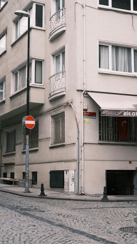 a white building with multiple windows and a sign