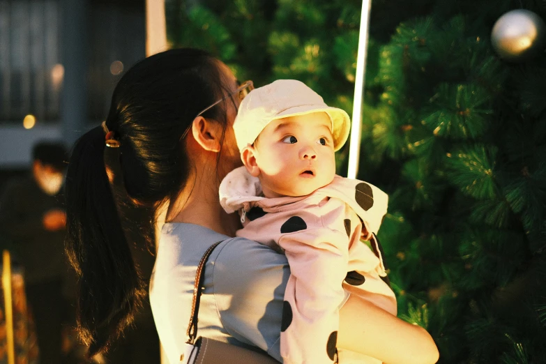 a woman carrying a small child in her arms