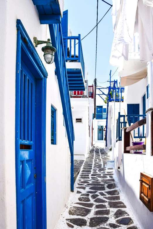 an empty street in a small village with blue door