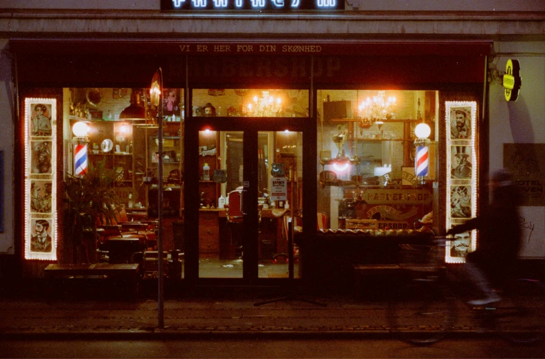 an antique store front lit up at night