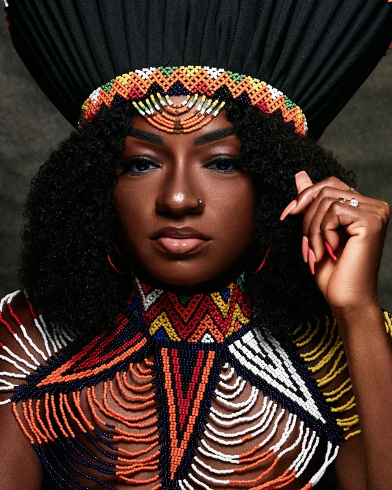 an african woman with an elaborate headpiece and very long black hair