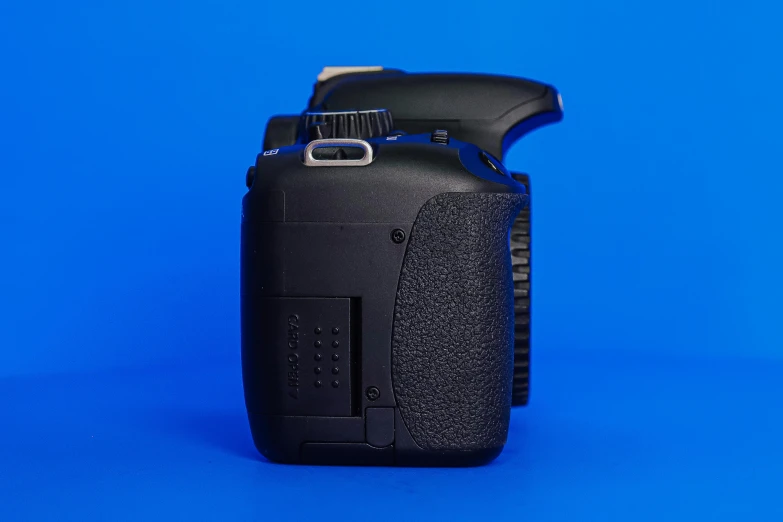 a camera with its case sitting on a blue surface
