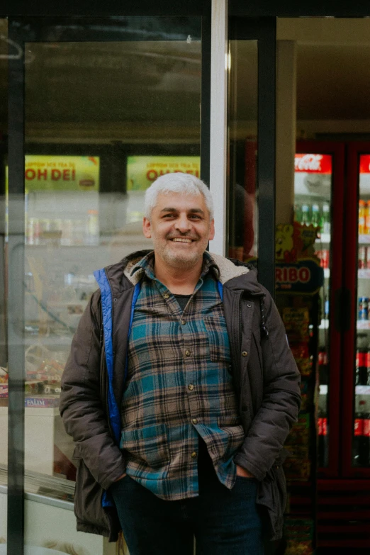 a man standing in front of a store window