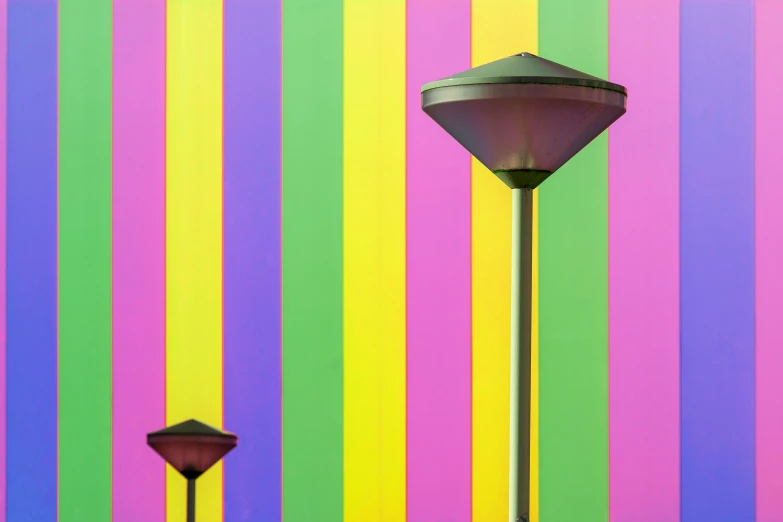 two lights are in front of some colorful walls