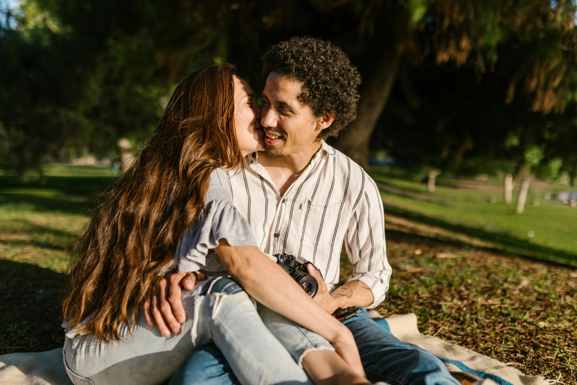 an adult kissing a child on the cheek