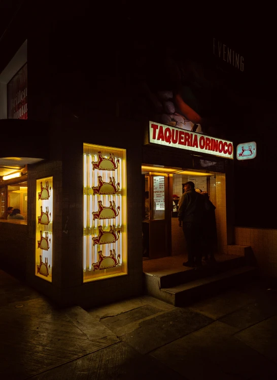 a shop front at night decorated with christmas lights