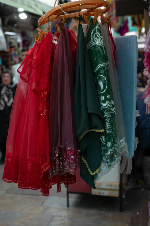 various dresses hanging in the window at a store