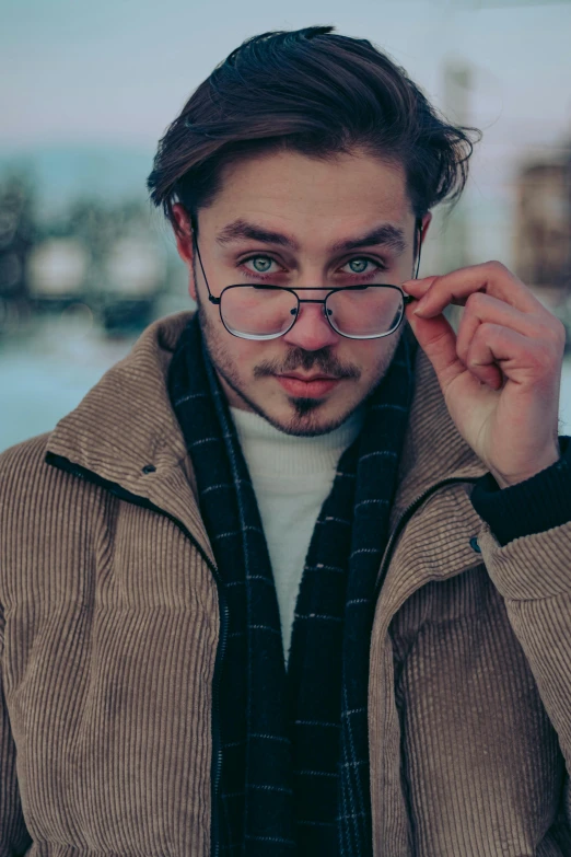 a man wearing glasses while wearing a scarf