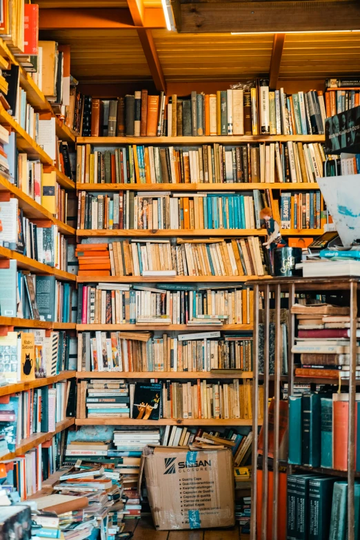 a room full of books and boxes on the floor