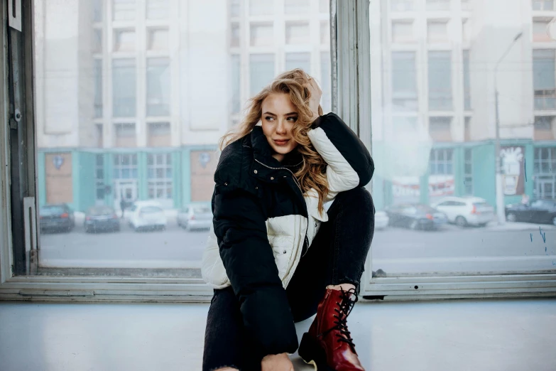 a woman in an airport posing by the window