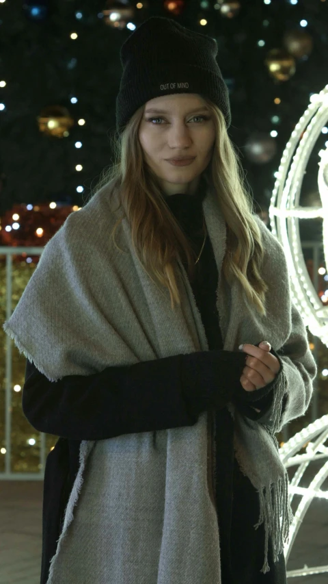 a woman in a wool cap is standing outside