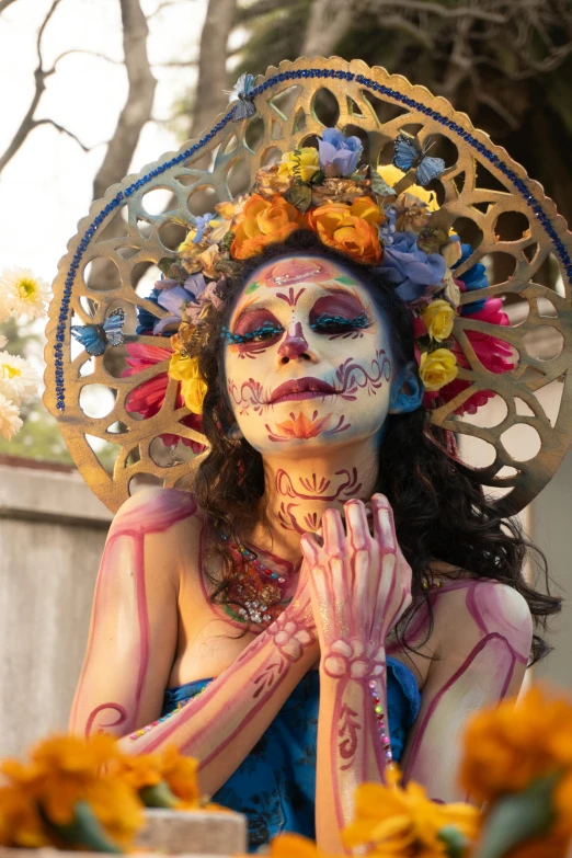 a woman with makeup in the shape of flowers and holding her face covered