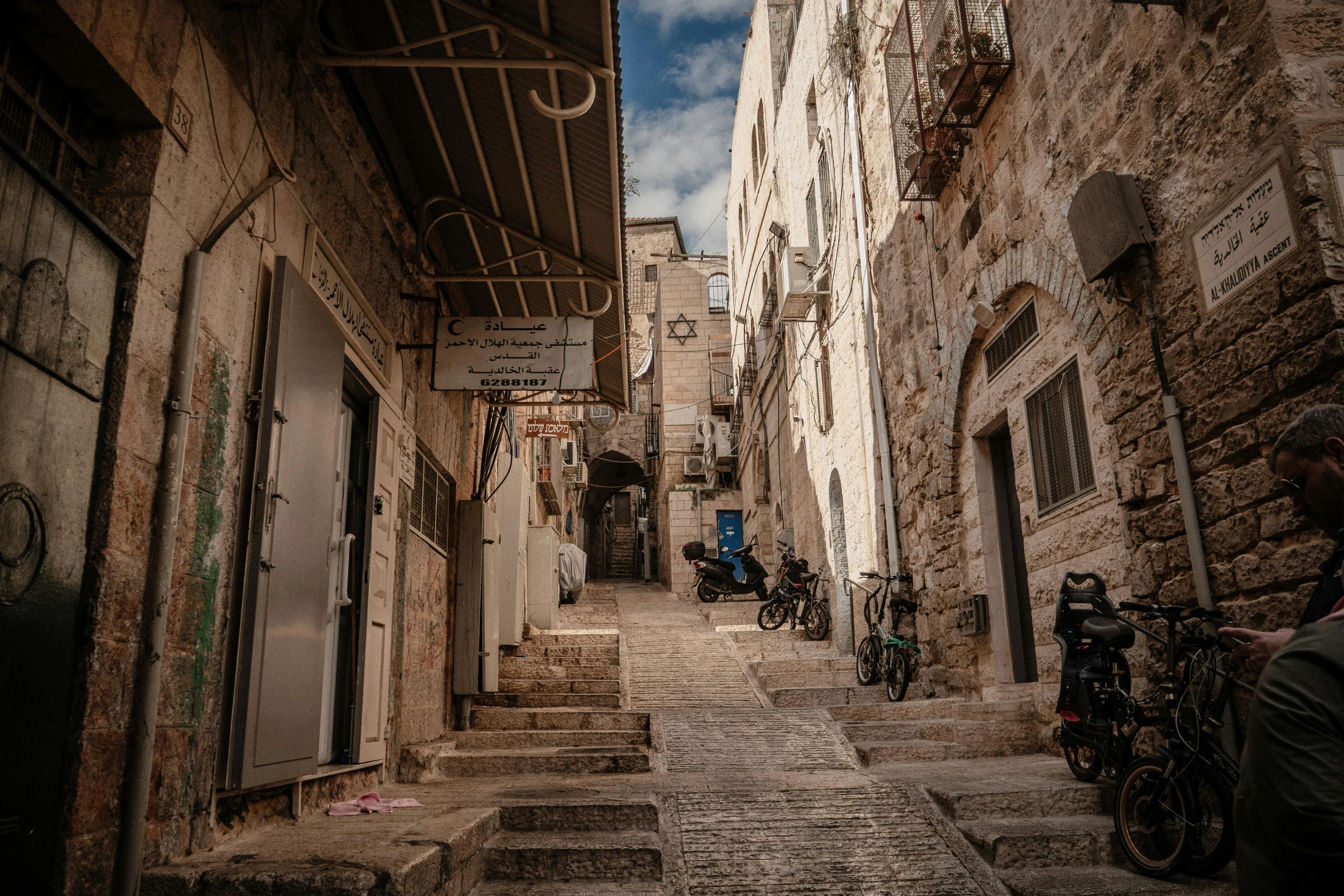 a narrow alley way leading into a bike parking lot