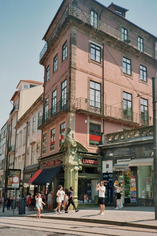 people walking down the street in front of buildings