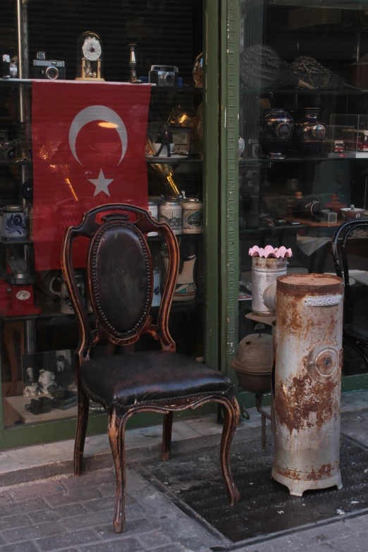 an old chair and table sit in front of a store
