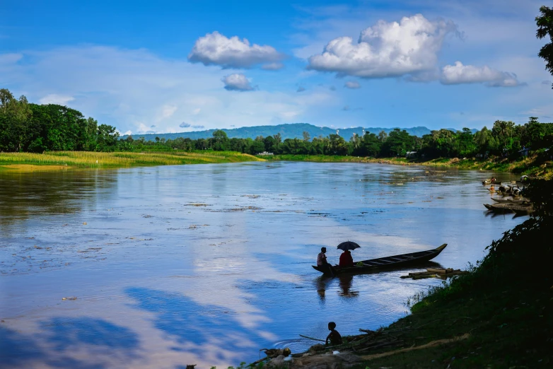 two men in a canoe paddling down the river