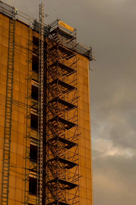 an industrial metal tower under a gray sky