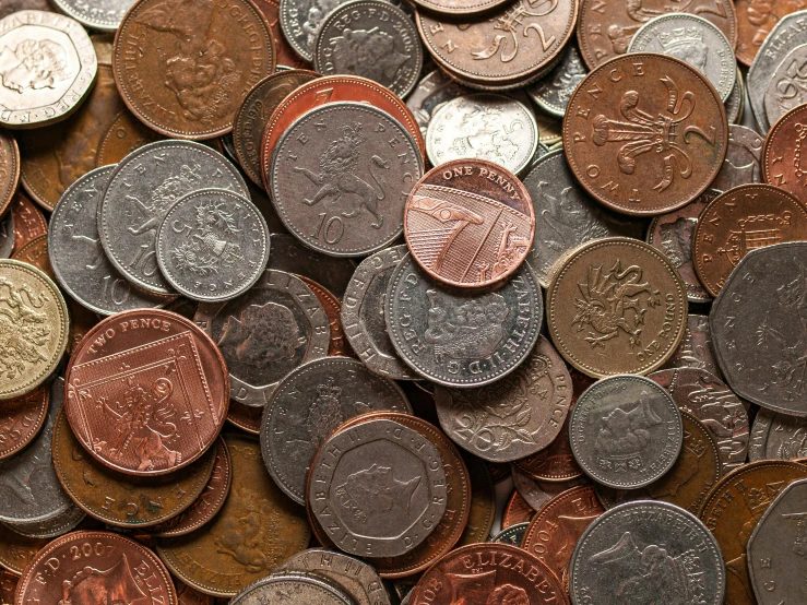 a pile of foreign coins that are mostly one euro