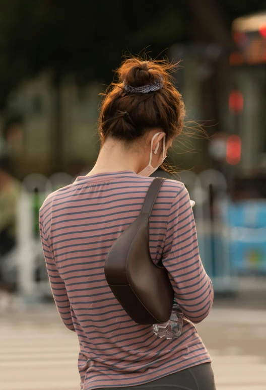 a woman in a striped top and her purse