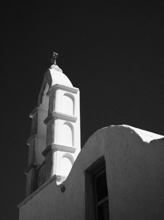 a tall tower at night with a white clock