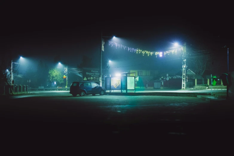 a dark street at night with some lights and lights