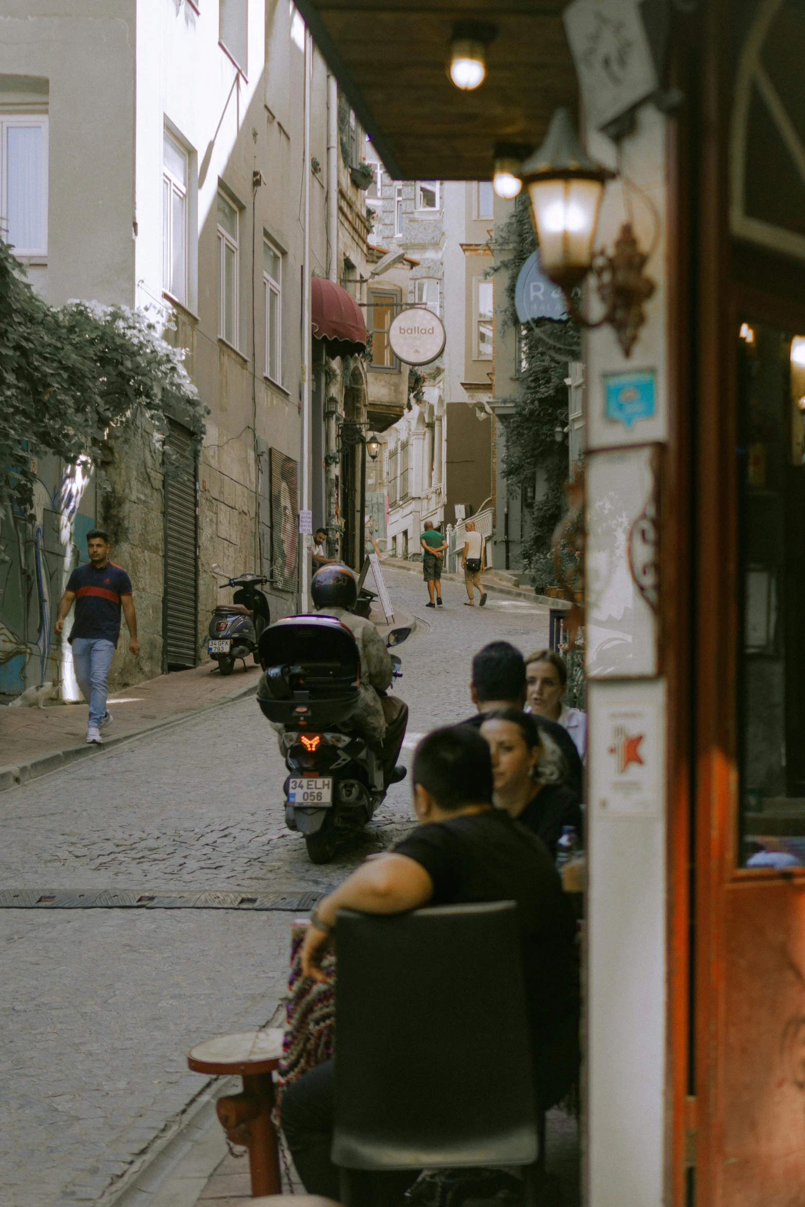 people are riding on a street cart on a city street