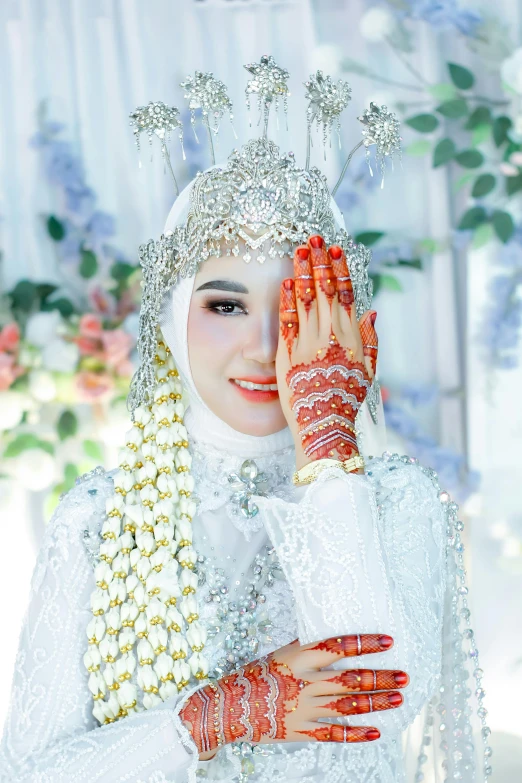 the bride is dressed in traditional clothing with elaborate jewelry