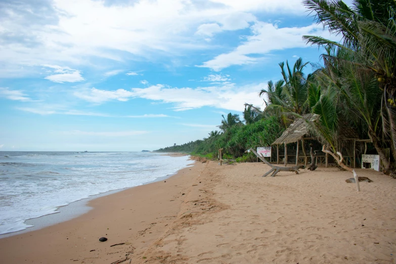 a beach with a house next to it