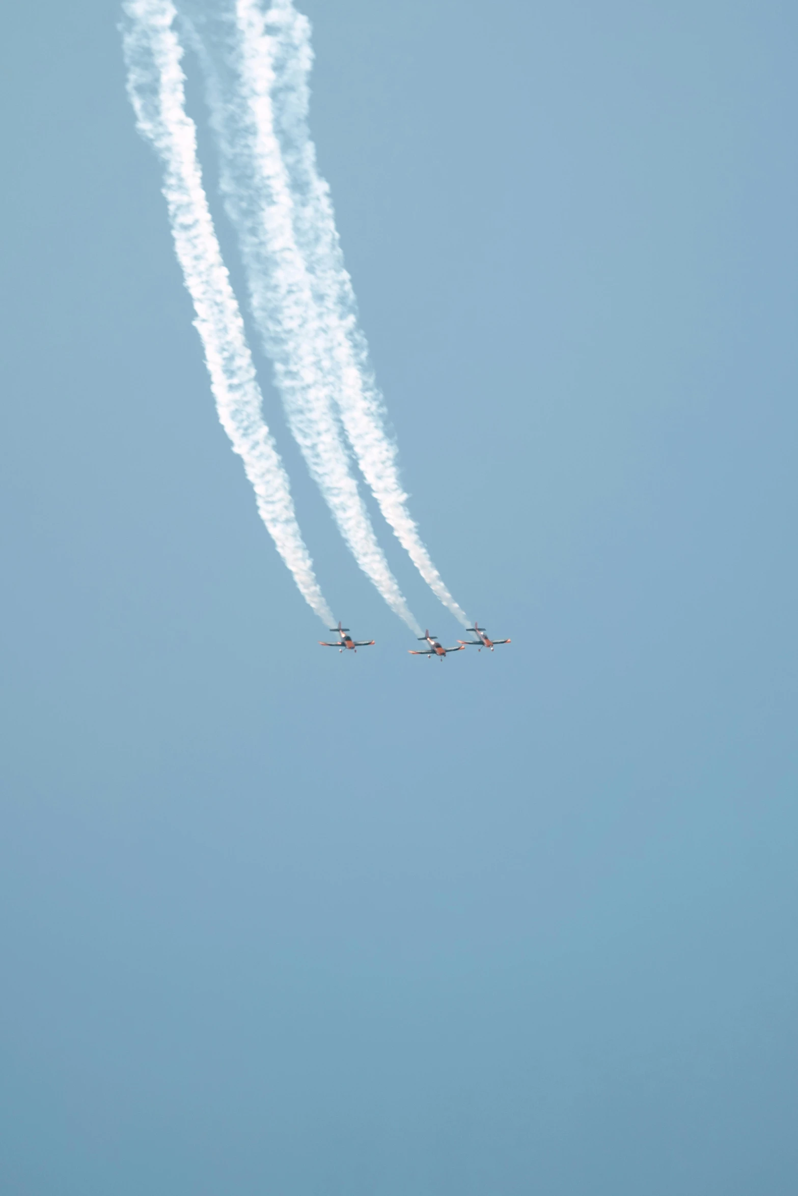 an air plane that has three airplanes flying through the sky