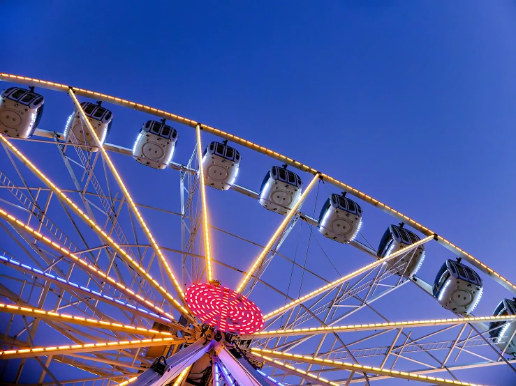 a ferris wheel sits with a lot of lights on it