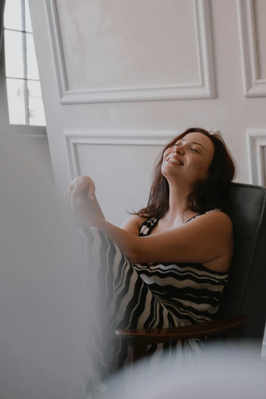 a women sitting on a chair and stretching