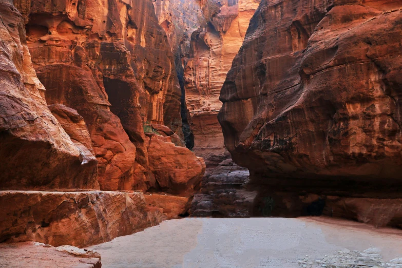 a narrow narrow river that is surrounded by tall rocks