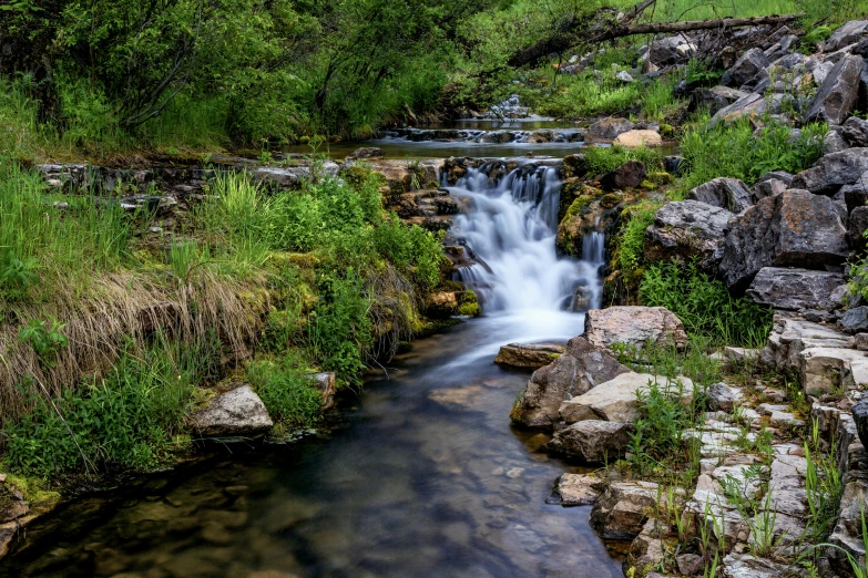 a very long waterfall with rocks in it