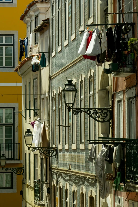 clothes hanging outside on the balconies next to windows