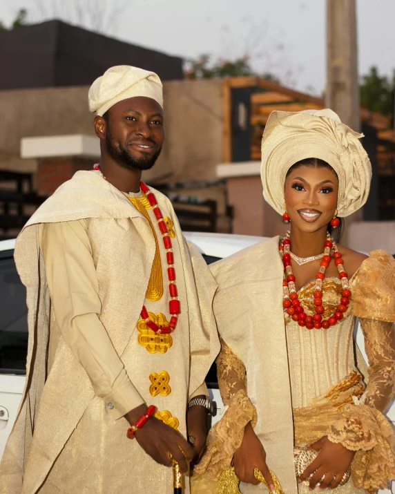 a man and woman wearing traditional african clothing