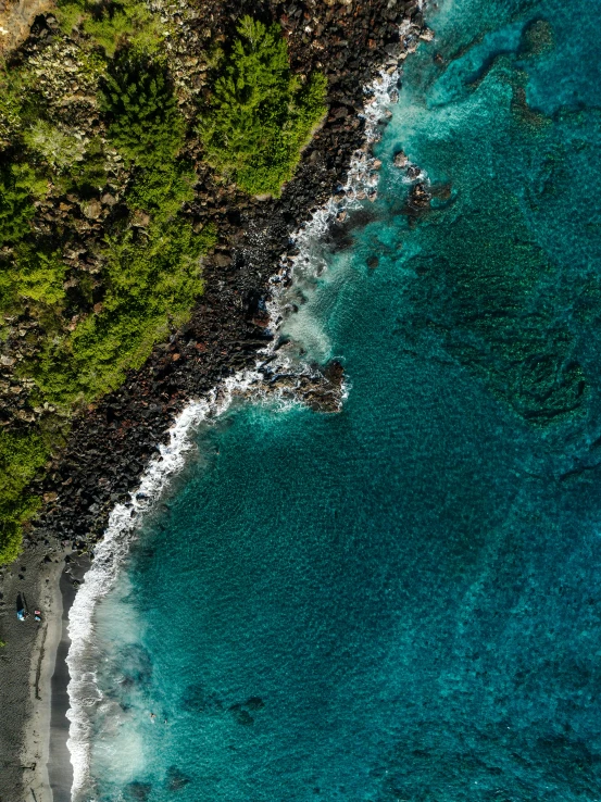 a sandy beach and shore line near a rocky cliff