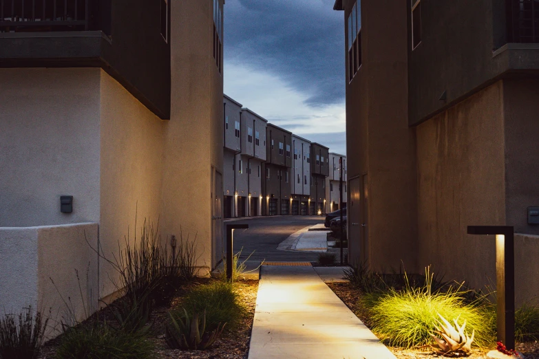 lights in the evening on an alley with sidewalk