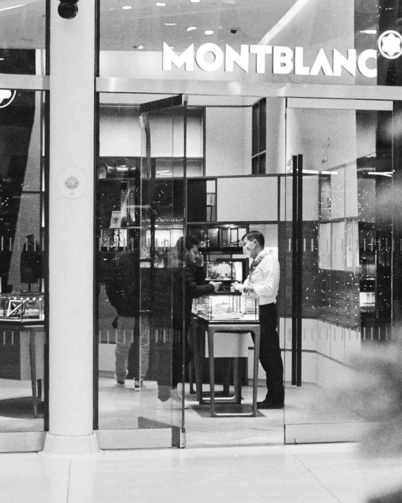 a man is outside a jewelry store with windows