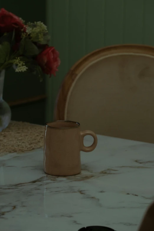 a table that has a brown cup on top of it