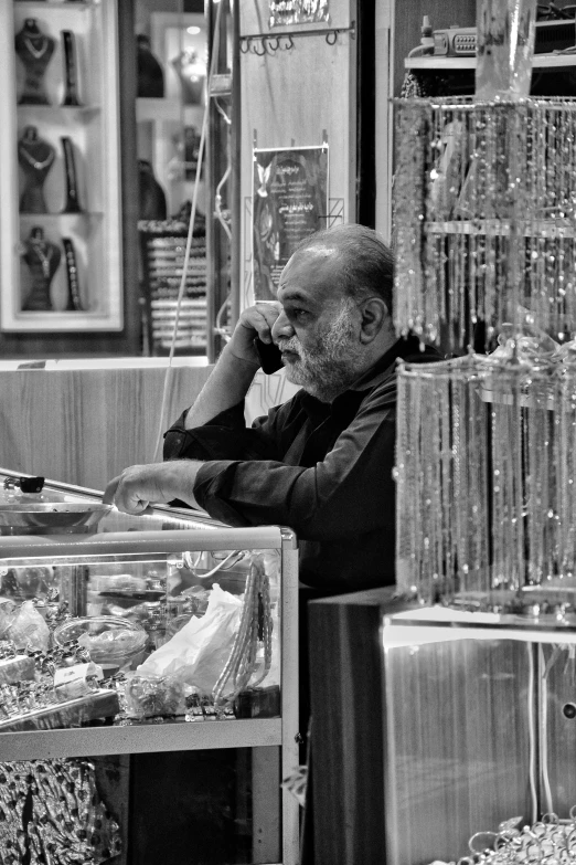 a man is sitting in front of the store