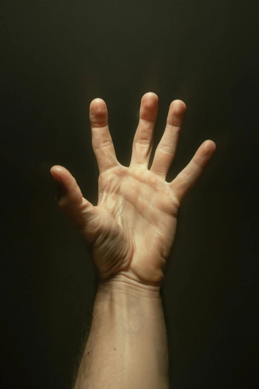 a hand reaching upward to reach soing in the air