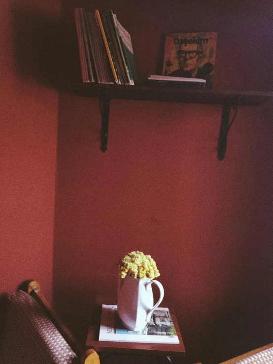 there is a vase with some flowers next to the books