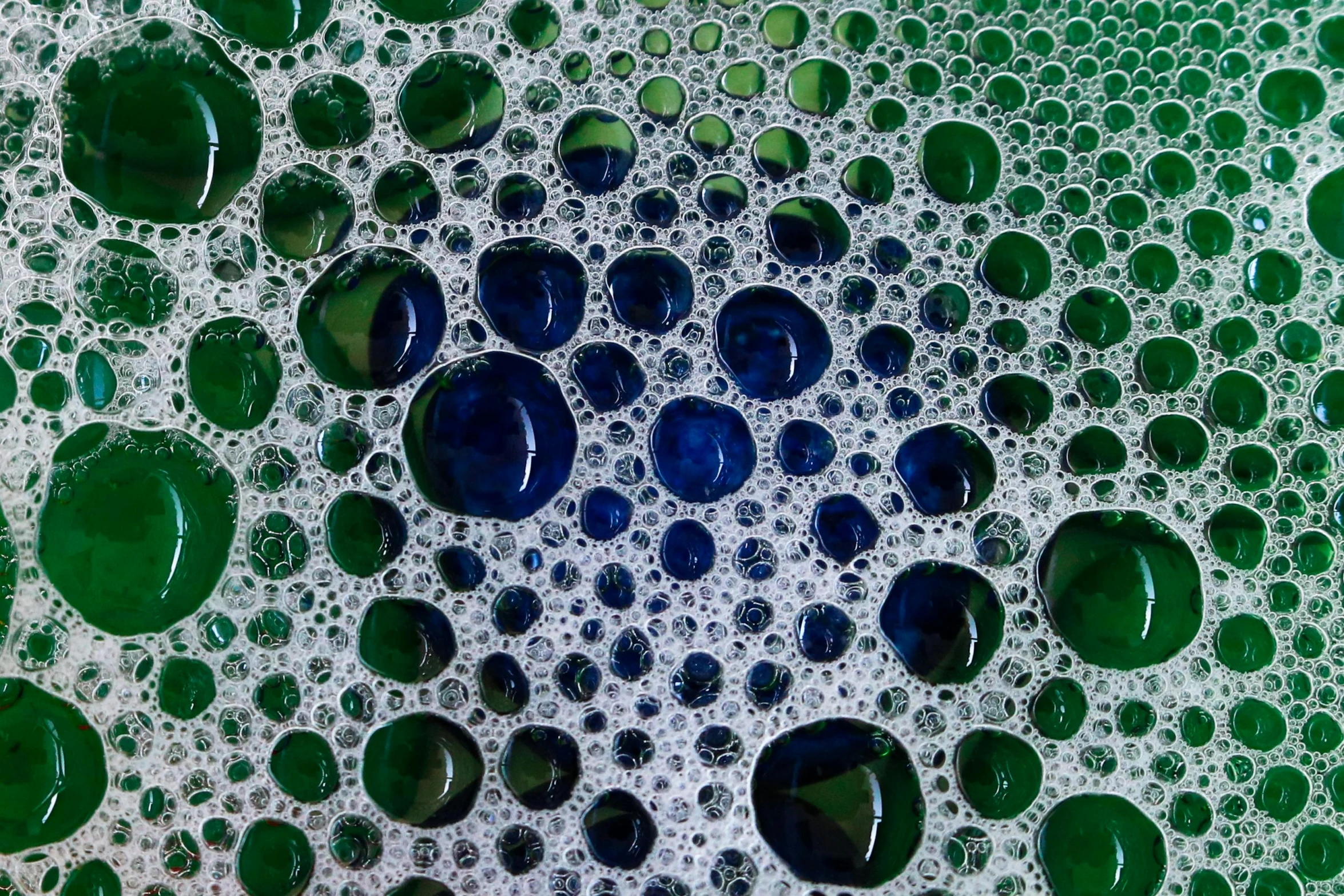 closeup view of bubbles and blue green drops