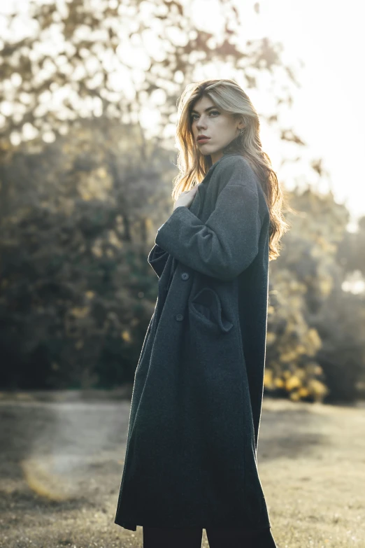 a woman standing on a grass covered field