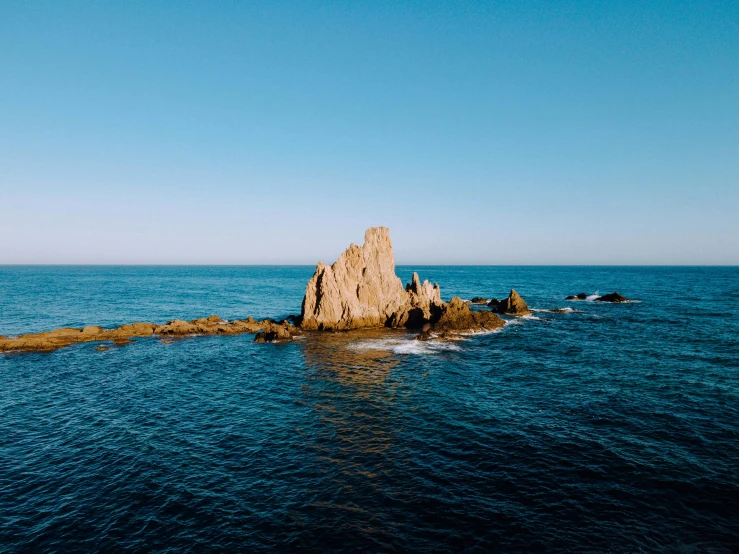 the rocks are in the middle of the water