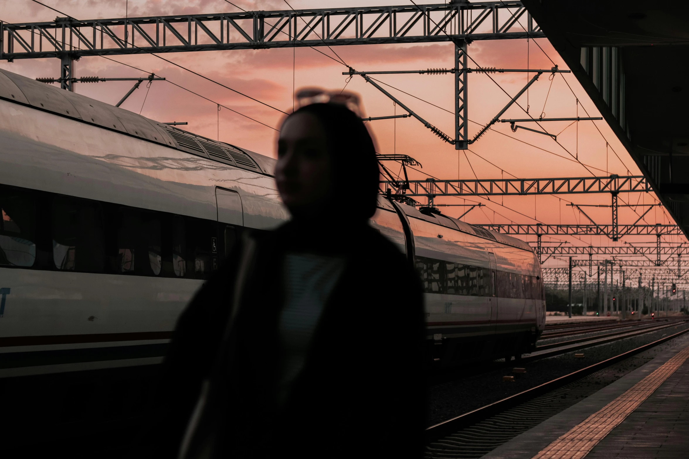 a woman standing in front of a train