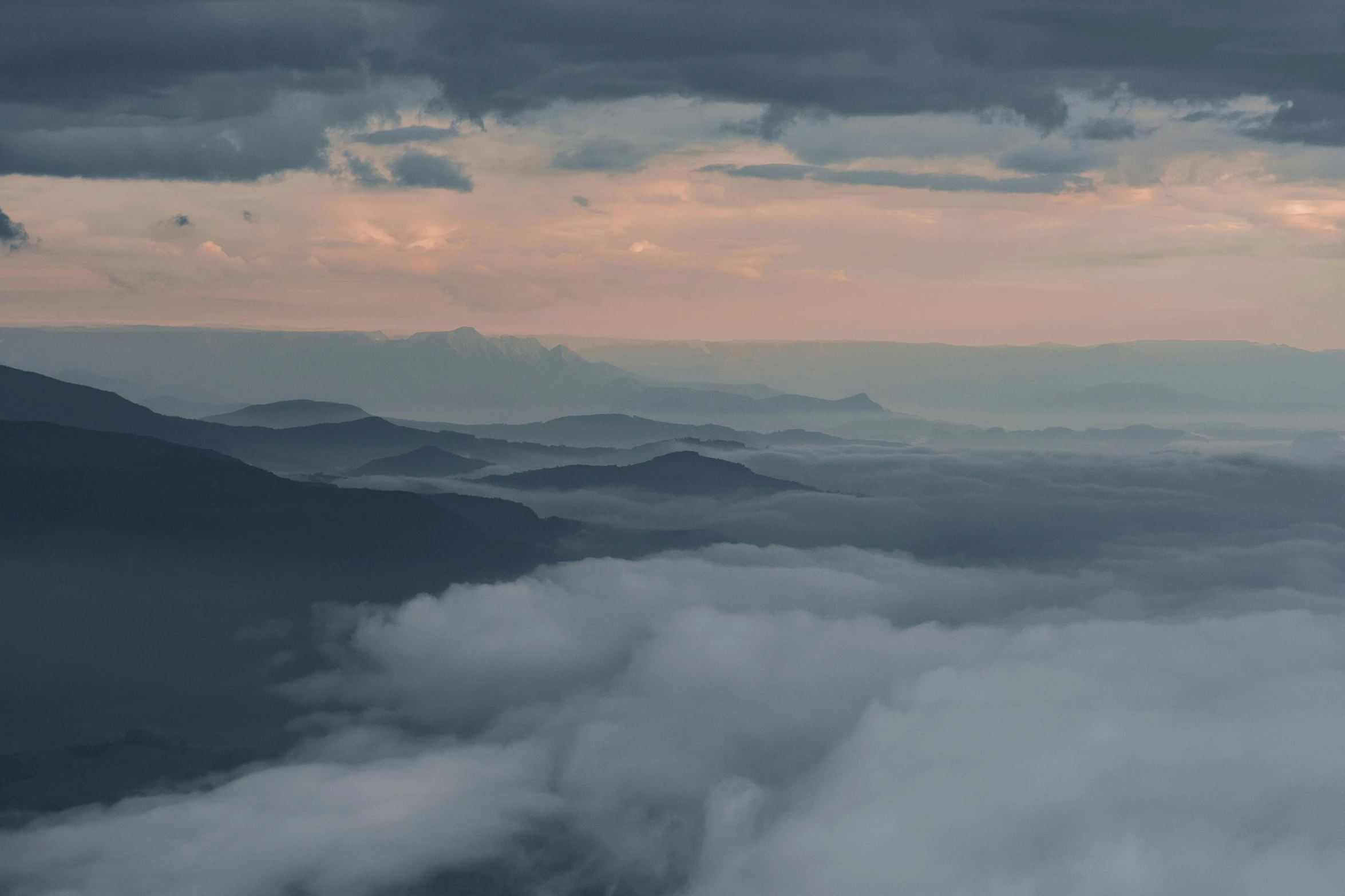 a distant view of mountains in the clouds