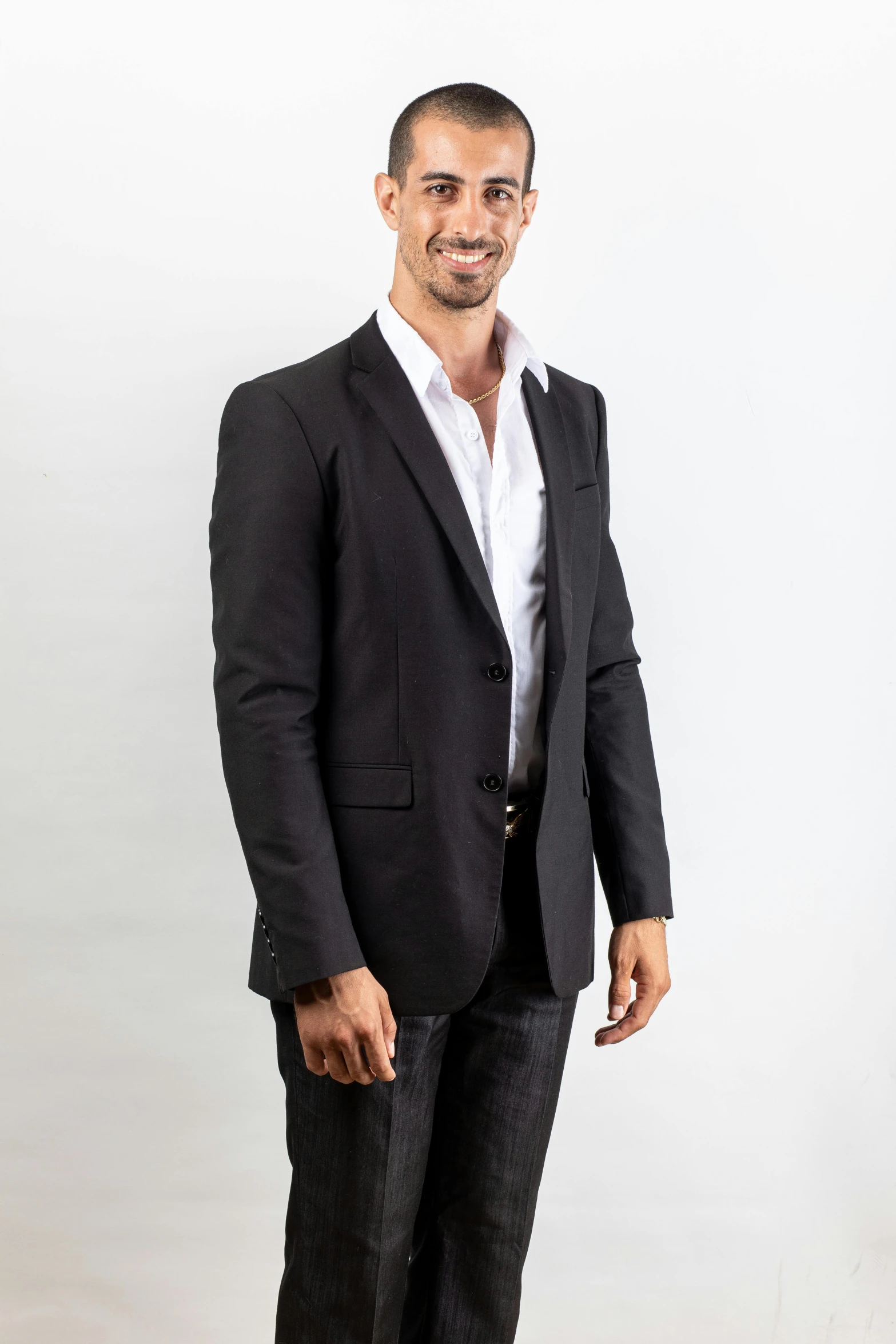 a man in a black blazer and white shirt standing