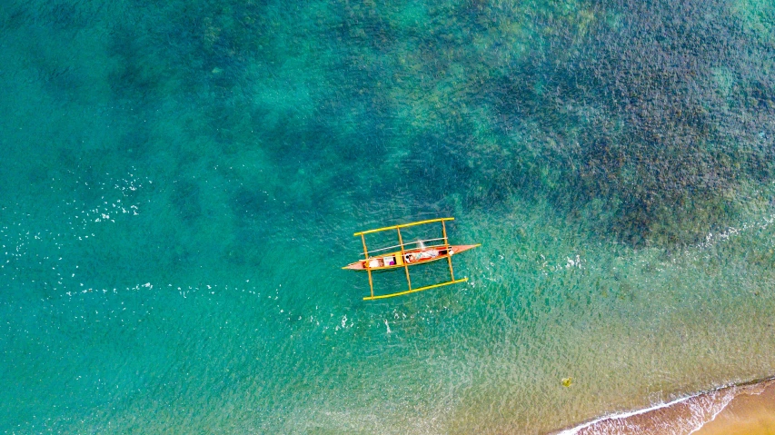 a man and woman are lying on the orange raft