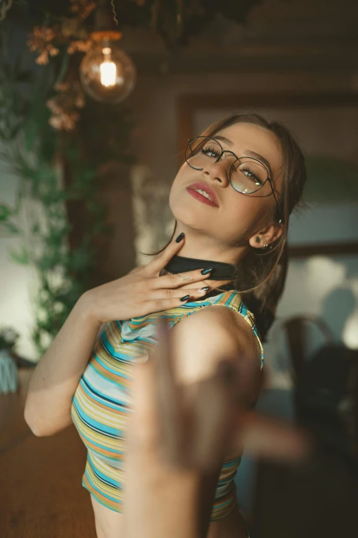 woman looking at herself in mirror wearing glasses